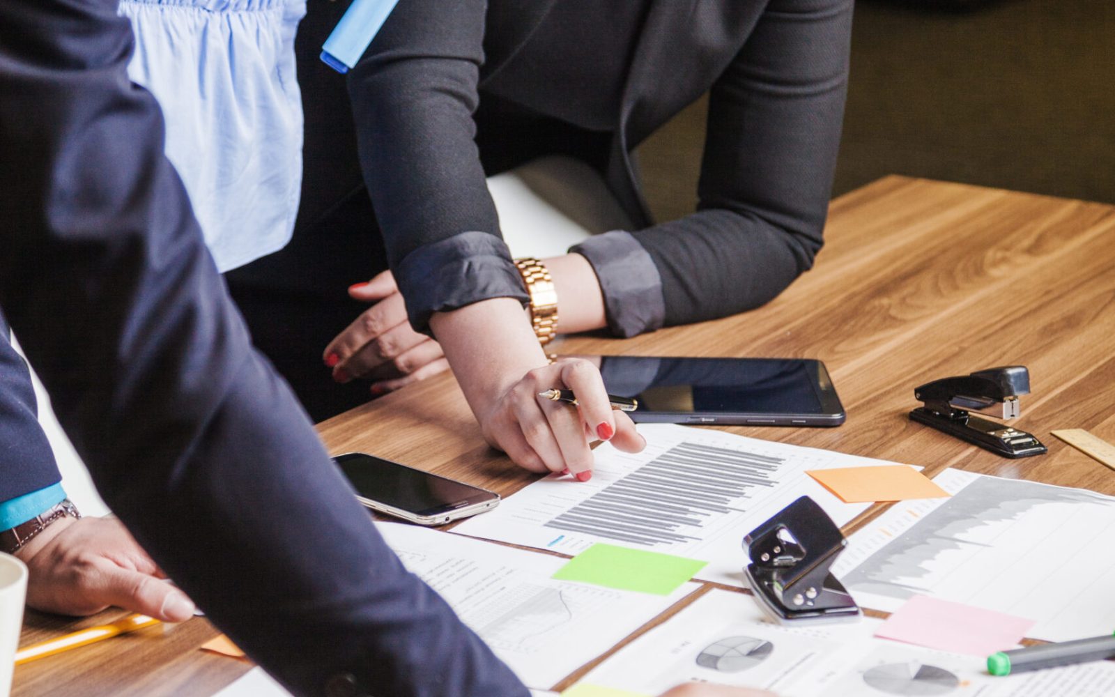 people-leaning-desk-standing